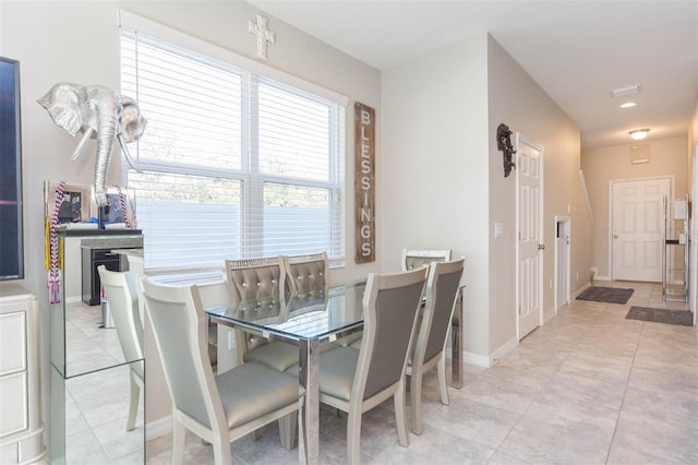 dining space featuring light tile patterned floors