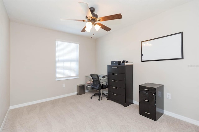 office area featuring light carpet and ceiling fan