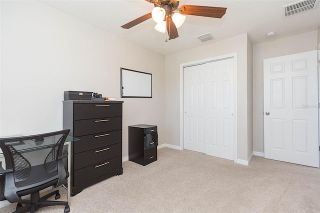 office space featuring light colored carpet and ceiling fan