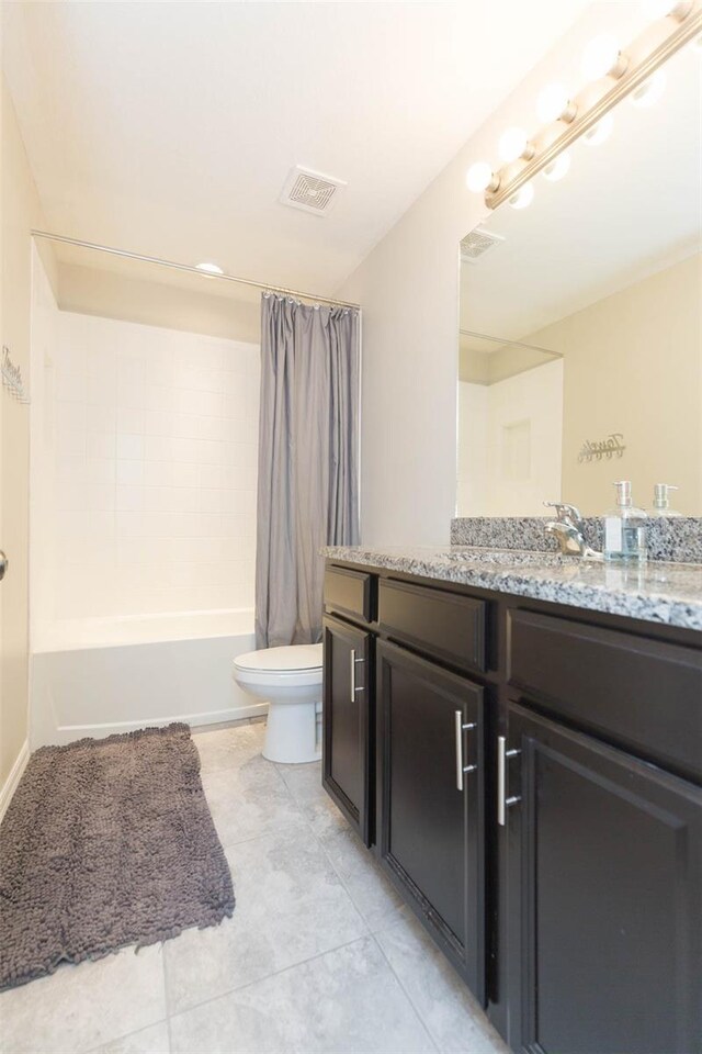 full bathroom with tile patterned flooring, shower / bath combo, vanity, and toilet