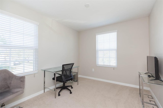 office with a healthy amount of sunlight and light carpet