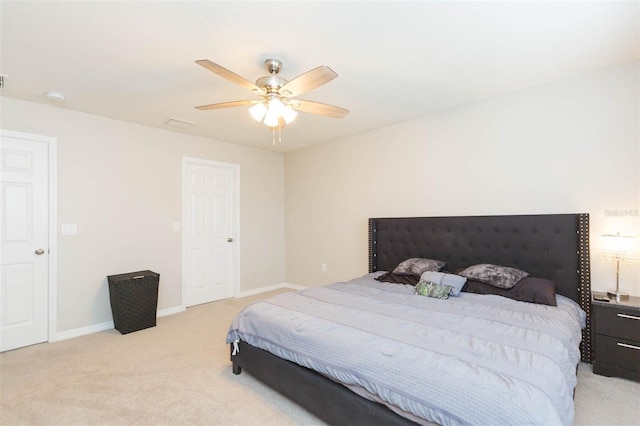 bedroom with ceiling fan and light carpet