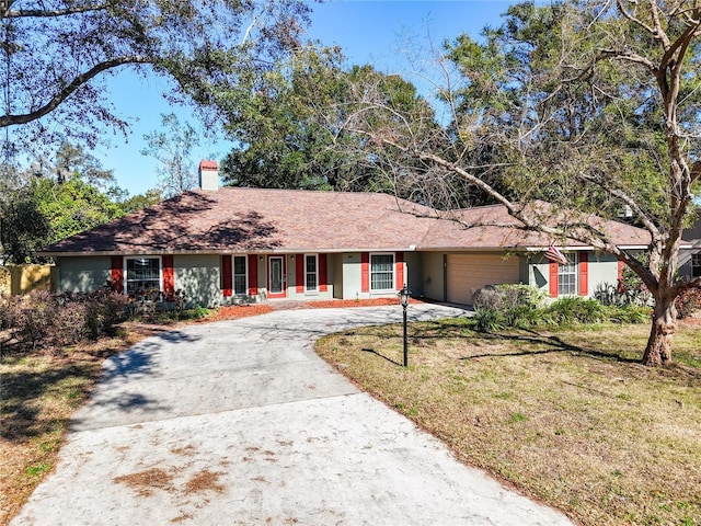 ranch-style house featuring a front yard and a garage