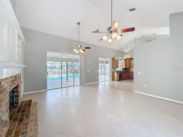 unfurnished living room with ceiling fan, light tile patterned flooring, vaulted ceiling, and a brick fireplace