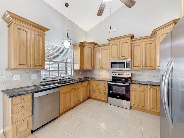 kitchen with lofted ceiling, sink, hanging light fixtures, ceiling fan, and appliances with stainless steel finishes