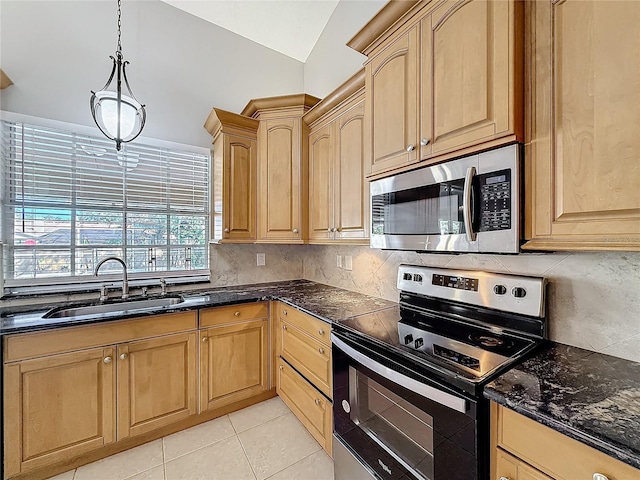 kitchen with sink, lofted ceiling, decorative light fixtures, light tile patterned flooring, and appliances with stainless steel finishes