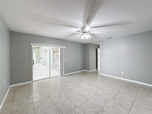 spare room with ceiling fan and a textured ceiling