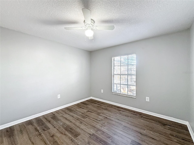 empty room with ceiling fan, dark hardwood / wood-style flooring, and a textured ceiling