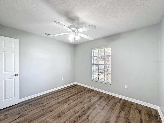 spare room featuring wood-type flooring, a textured ceiling, and ceiling fan