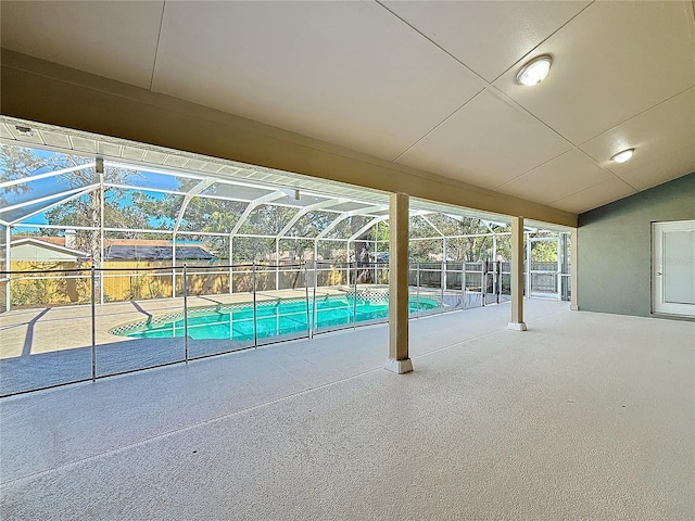 view of swimming pool featuring a lanai and a patio area