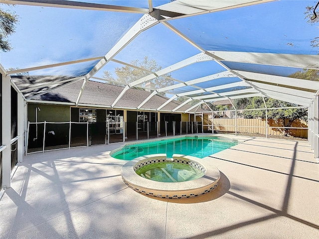 view of pool with a patio area, a lanai, and an in ground hot tub