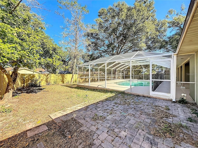 view of yard featuring a lanai, a patio, and a fenced in pool