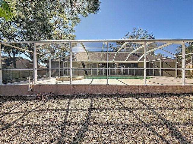 view of pool featuring glass enclosure