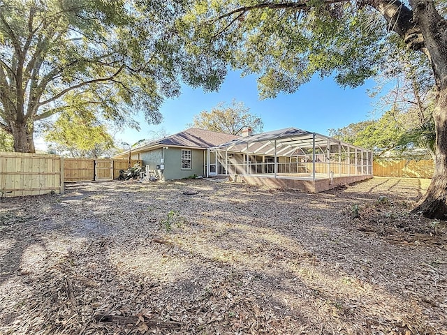 rear view of property with glass enclosure