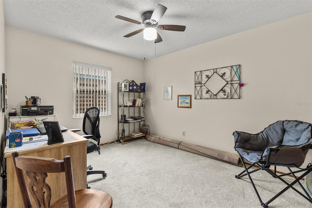 carpeted office with ceiling fan and a textured ceiling