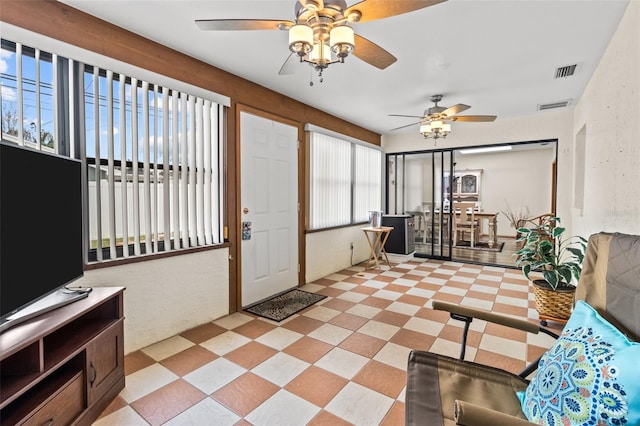 interior space featuring ceiling fan and plenty of natural light