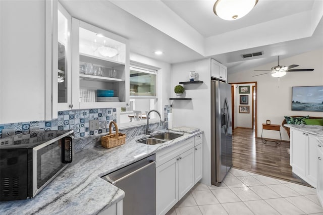 kitchen with ceiling fan, stainless steel appliances, white cabinets, and sink