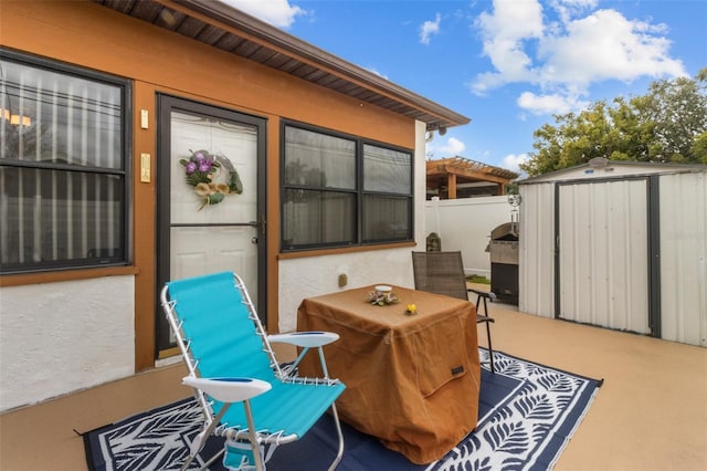 view of patio / terrace featuring a storage unit