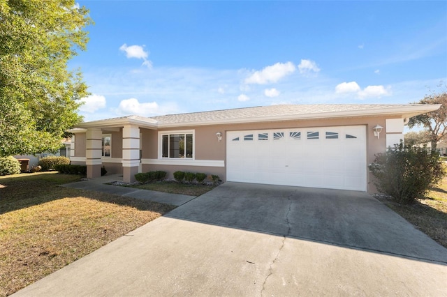 single story home with a garage and a front lawn