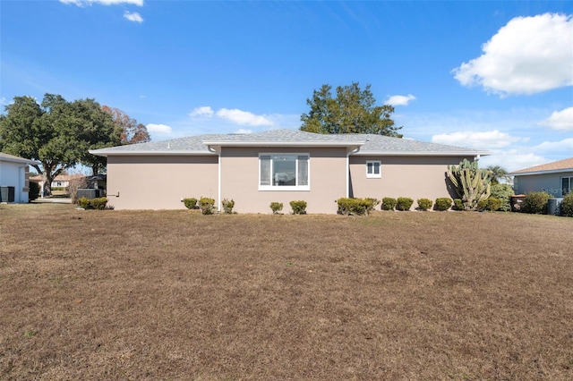 exterior space with a lawn and central AC