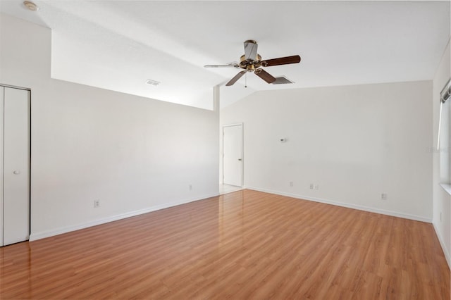 unfurnished room with ceiling fan, light hardwood / wood-style flooring, and lofted ceiling