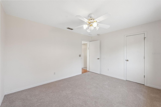 unfurnished bedroom featuring ceiling fan and light colored carpet