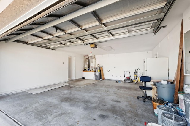 garage with a garage door opener and white fridge