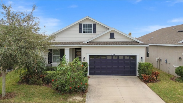 view of front of home with a garage and a front yard