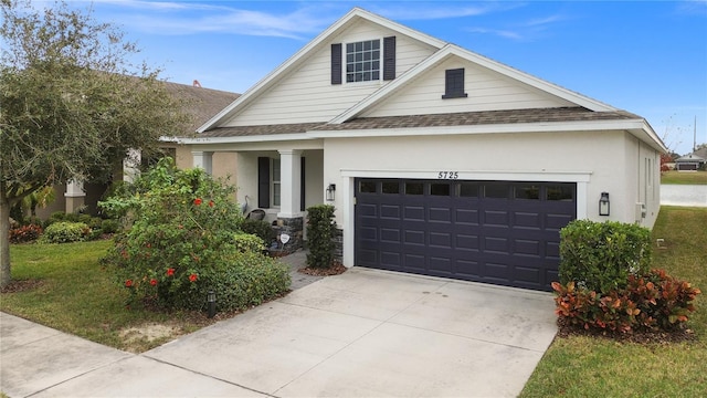 view of front of house featuring a front yard and a garage