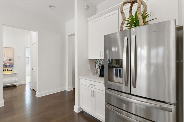 kitchen with white cabinets, stainless steel fridge, and dark hardwood / wood-style floors