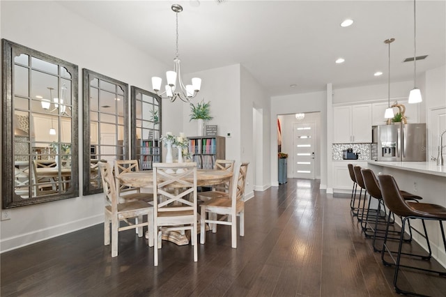 dining area featuring a chandelier and dark hardwood / wood-style floors