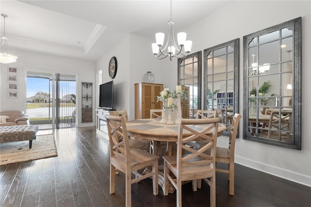 dining space with an inviting chandelier, crown molding, dark hardwood / wood-style floors, and a tray ceiling