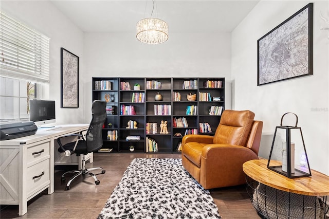 office featuring dark wood-type flooring and a notable chandelier