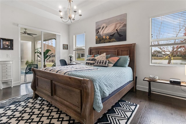 bedroom with an inviting chandelier, dark hardwood / wood-style flooring, and access to exterior