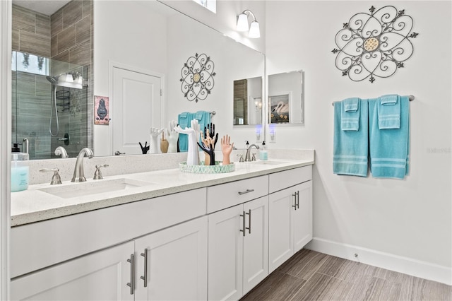 bathroom featuring vanity and a shower with door