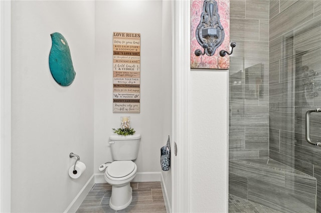 bathroom featuring toilet and an enclosed shower