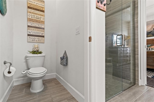 bathroom with toilet and an enclosed shower