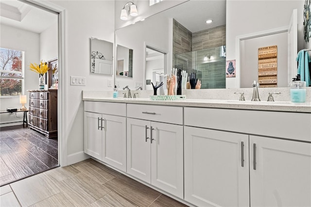 bathroom with a shower with shower door and vanity