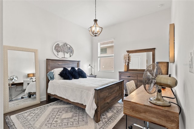 bedroom featuring wood-type flooring and a notable chandelier