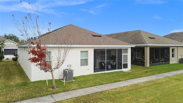 rear view of house featuring a sunroom, cooling unit, and a lawn