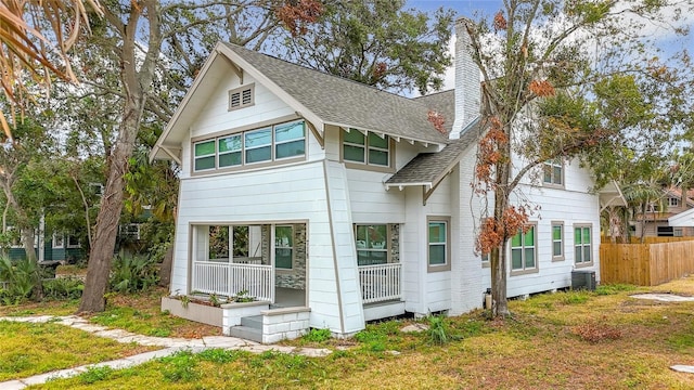 exterior space with a lawn, central air condition unit, and covered porch