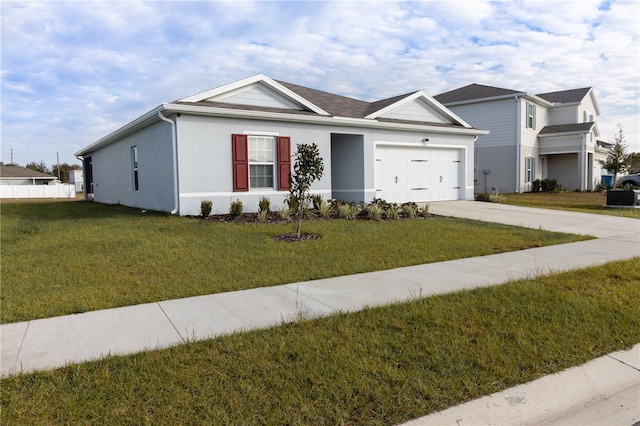 view of front of property with a garage and a front lawn