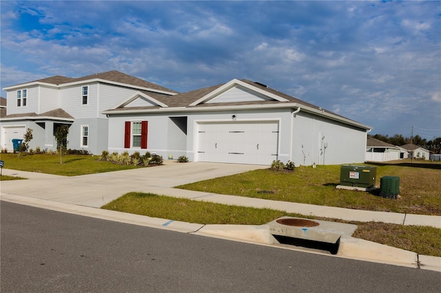 view of front of property featuring a front yard and a garage