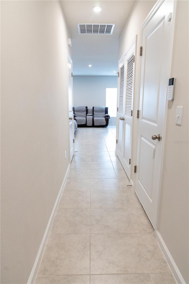 corridor with light tile patterned flooring