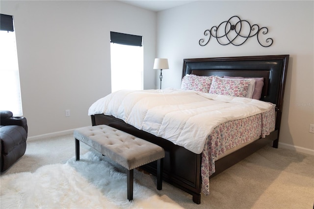 bedroom featuring multiple windows and light carpet