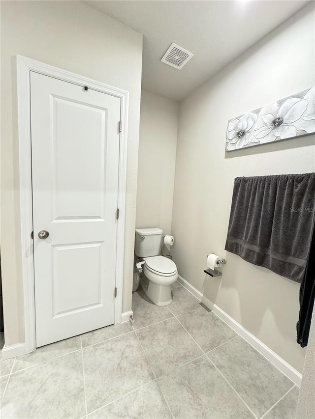 bathroom featuring toilet and tile patterned floors