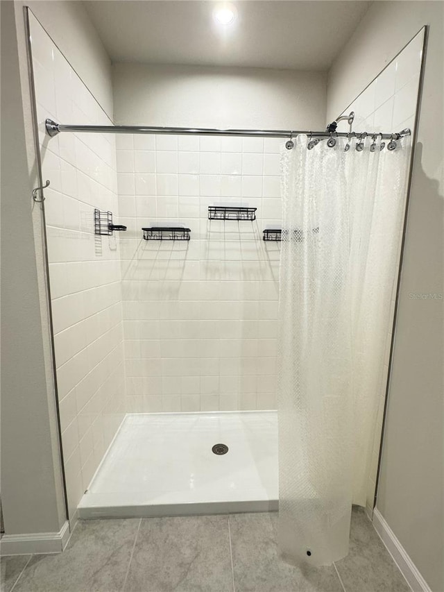 bathroom with tile patterned floors and a shower with curtain