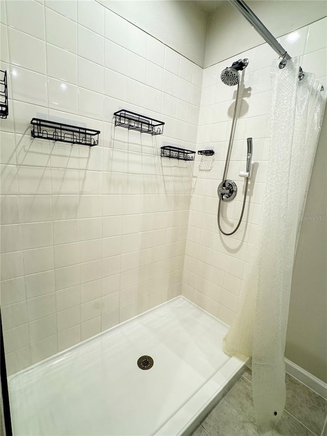 bathroom with tile patterned flooring and walk in shower