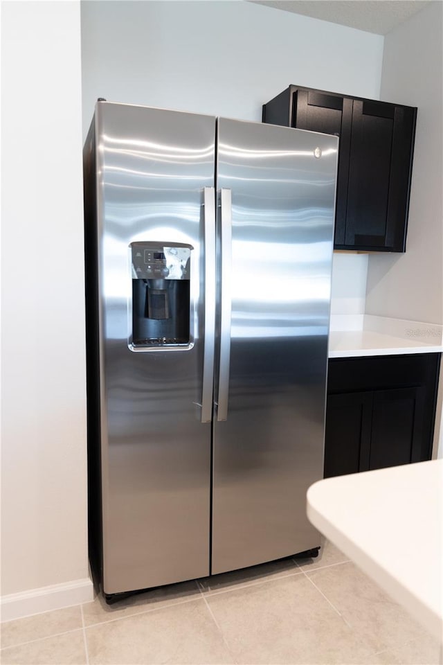 kitchen with stainless steel refrigerator with ice dispenser and light tile patterned floors