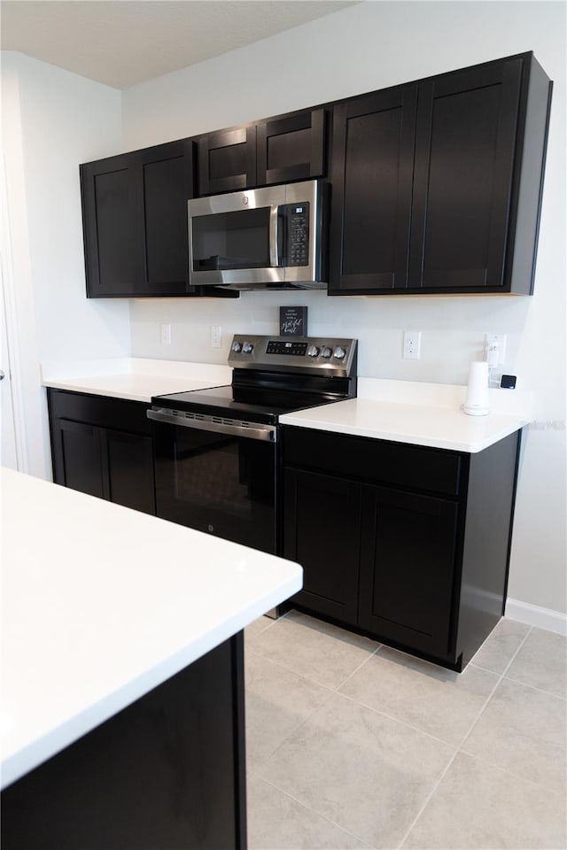 kitchen with appliances with stainless steel finishes and light tile patterned floors